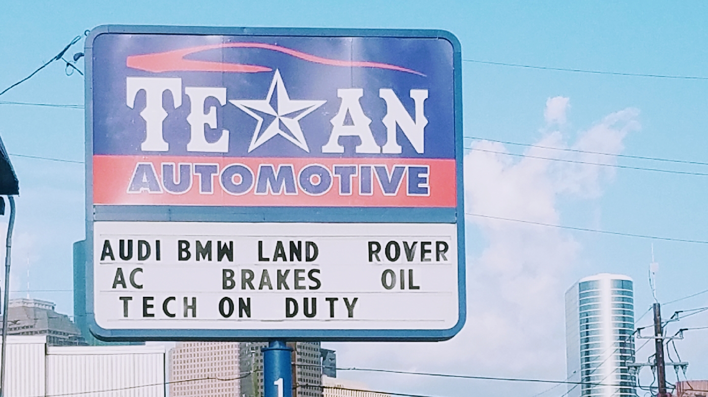 Texan Automotive sign advertising Audi, BMW and Land Rover service in Houston